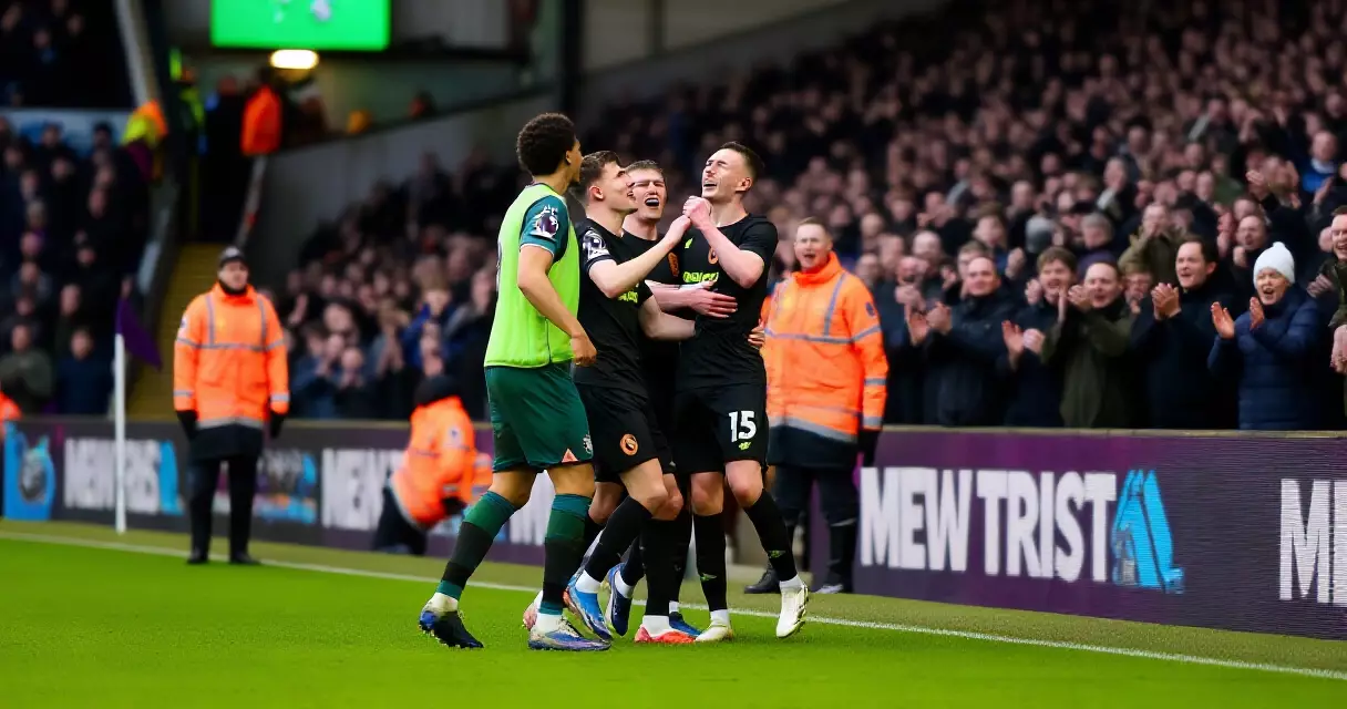 Premier League players celebrate an away goal in front of travelling fans