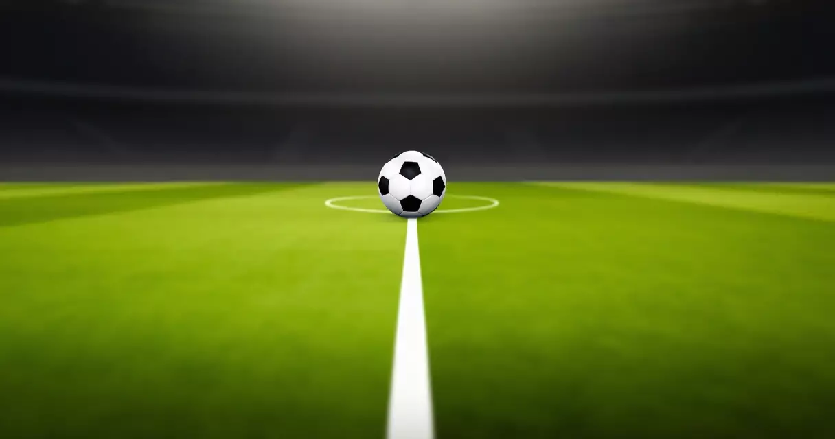 A football resting on the penalty spot of a Champions League pitch
