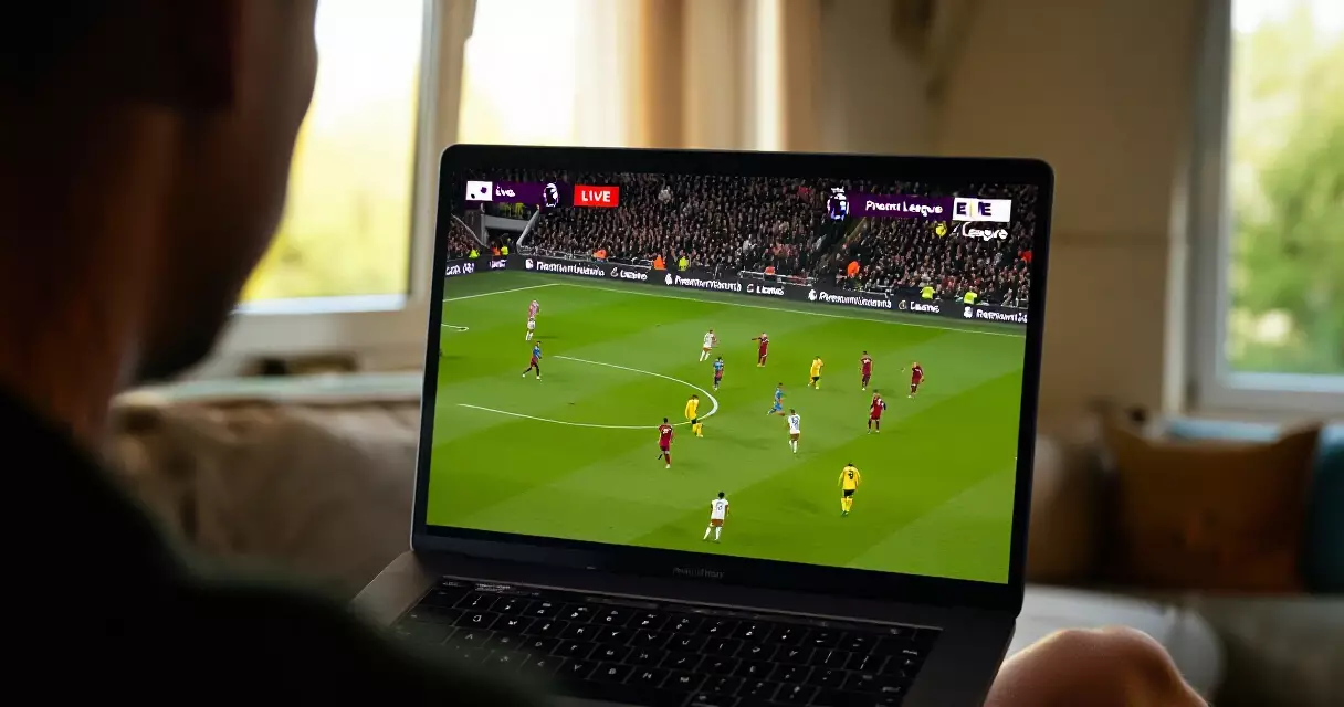 Fan tracking live Premier League midweek results on a laptop at home