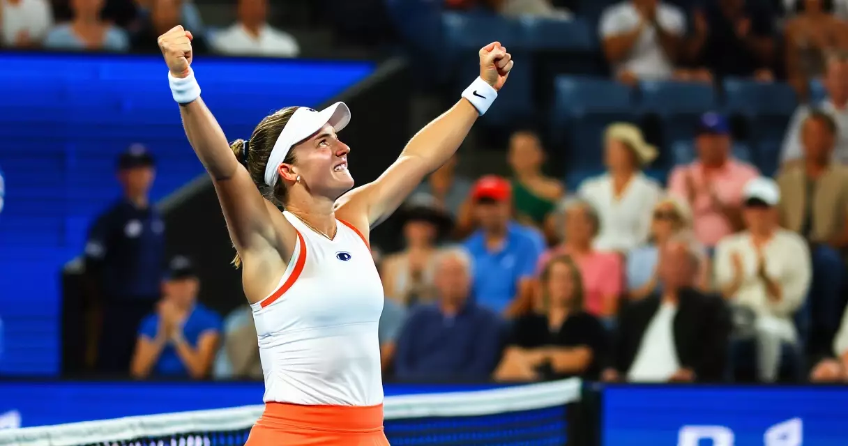 Female tennis player celebrating title win at Cincinnati Open hard court stadium