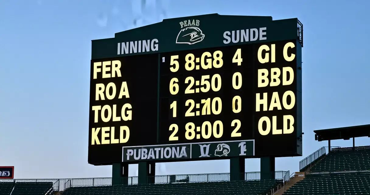 Baseball stadium scoreboard showing inning runs and team totals at dusk