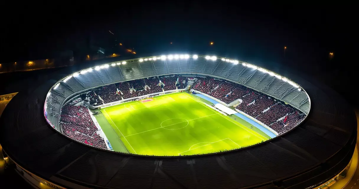 Champions League final stadium packed with fans under floodlights at night