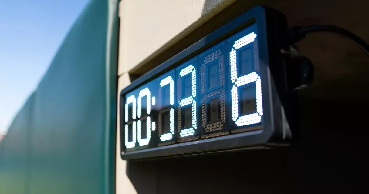 Pitch timer counting down on an MLB outfield wall during a day game