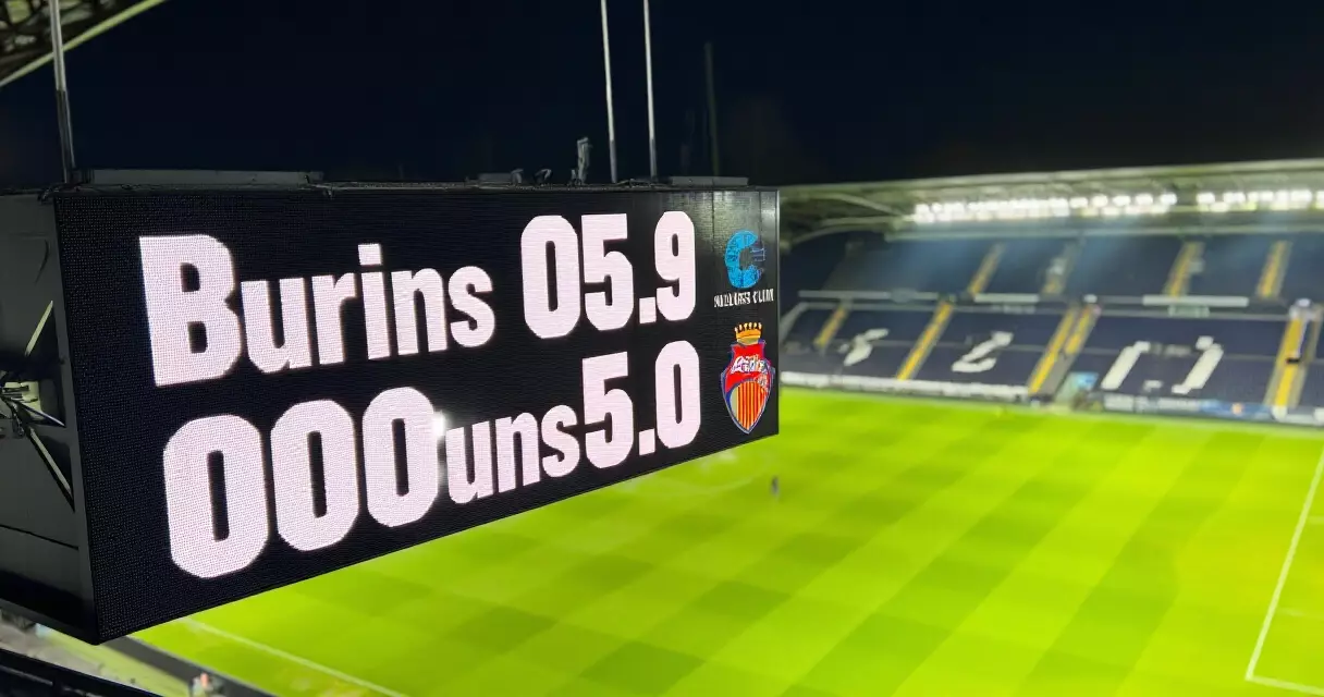 Premier League stadium scoreboard at night showing match result during post-match analysis